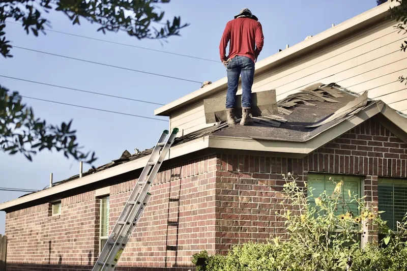 Professional roofer working on a residential roof in Kentfield